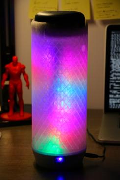 An Alexa pod with colored lights around it that act as visualizers when listening to music.