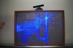 A screen with the shape of a person created with blue lights.