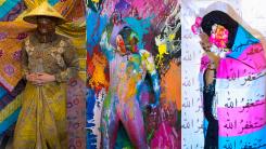Three stills from three different videos. First, a person in patterned garb and a straw hat. Second, a person in a body suit covered in different colored paint and wearing two masks. Third, a person with a hijab on, covering their face with pink flowers in their hands and the transgender pride flag wrapped around them.