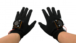 Black gloves with electronics (peltier device, raspberry pi, etc.) on them.