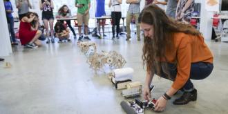 Student setting up her robot for the robot race. 