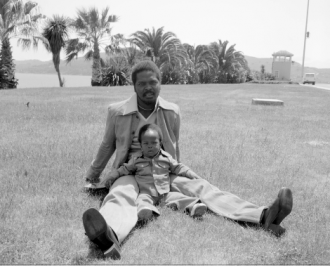 Man and child sitting on grass