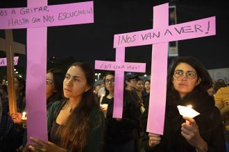 Demonstrators protest feminicide and violence against women on the International Day for the Elimination of Violence against Women in Mexico City, Mexico, on Nov. 25, 2019. UC Berkeley graduate student Laila Espinoza says these magenta crosses, planted all over the city of Ciudad Juárez and across the country, are powerful and enduring symbols of resistance and a way to reclaim public space and make the ongoing feminicides visible, when the government refuses to do so.