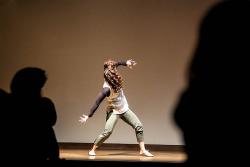 Dancer Nitzan Lederman dancing onstage.