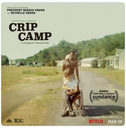 Photo of Crip Camp poster, with a man in a wheelchair being pushed by another man on a dirt road.
